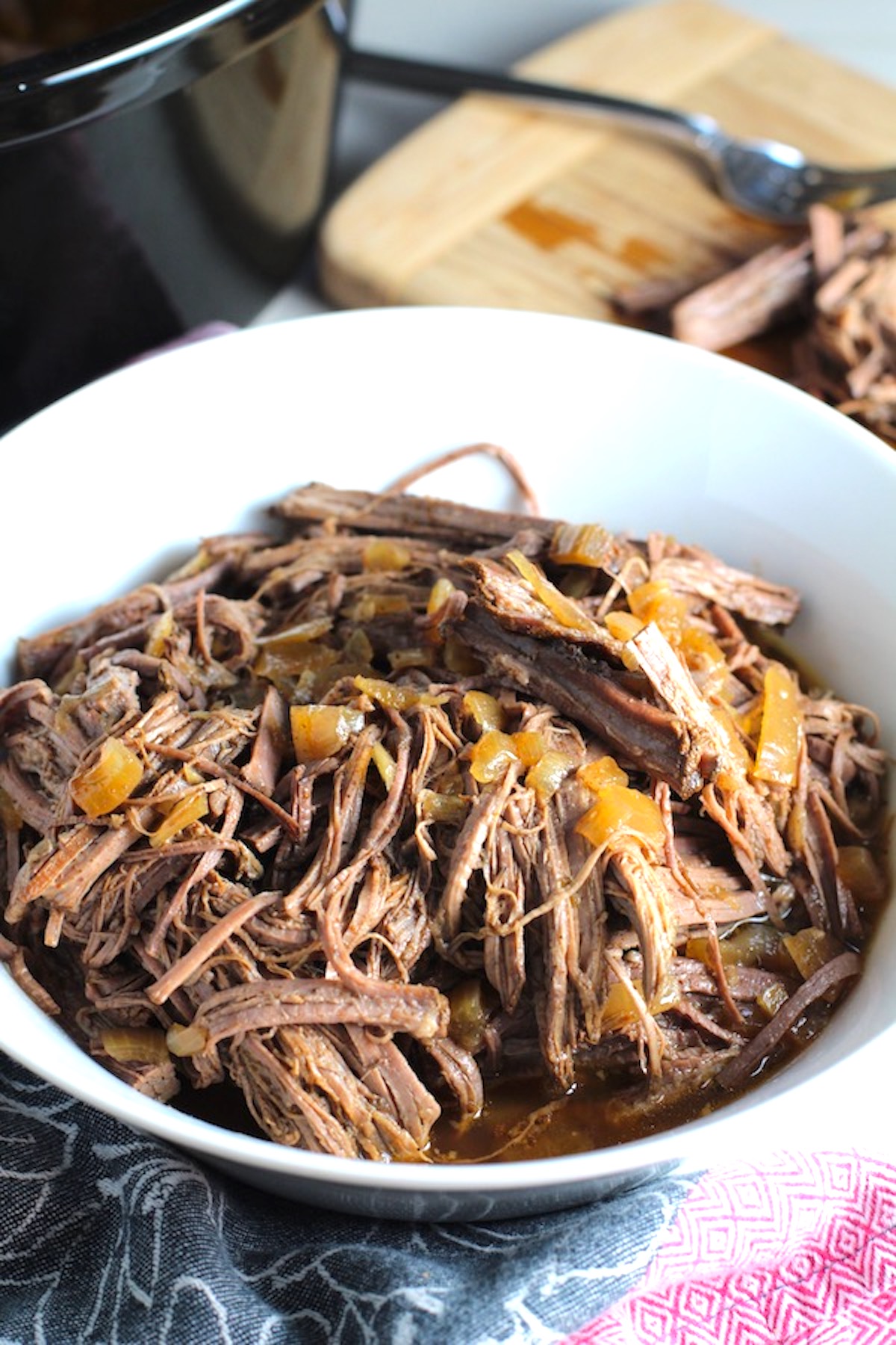 Pulled Beef Brisket in a bowl and in the Slow Cooker is smokey, savory, tender, moist, and full of flavor. In a delicious sauce, it goes great on a sandwich, over polenta, on rice, or potatoes. #slowcooker #crockpot #brisket #beefbrisket #pulledbeef #pulledpork