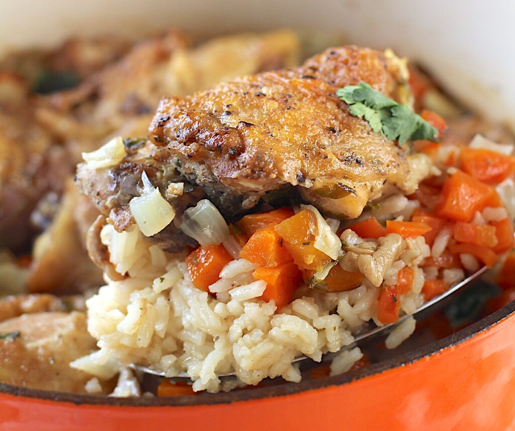 Spoon Scooping up Roasted Chicken Rice from a pot.