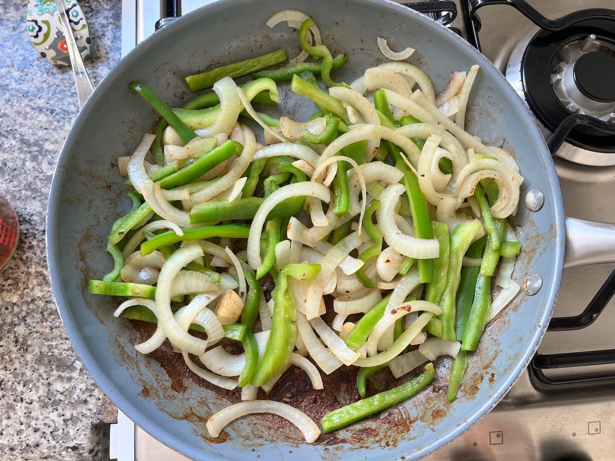 Onions and green peppers in a skillet for Philly Cheesesteak casserole recipe with Steak.