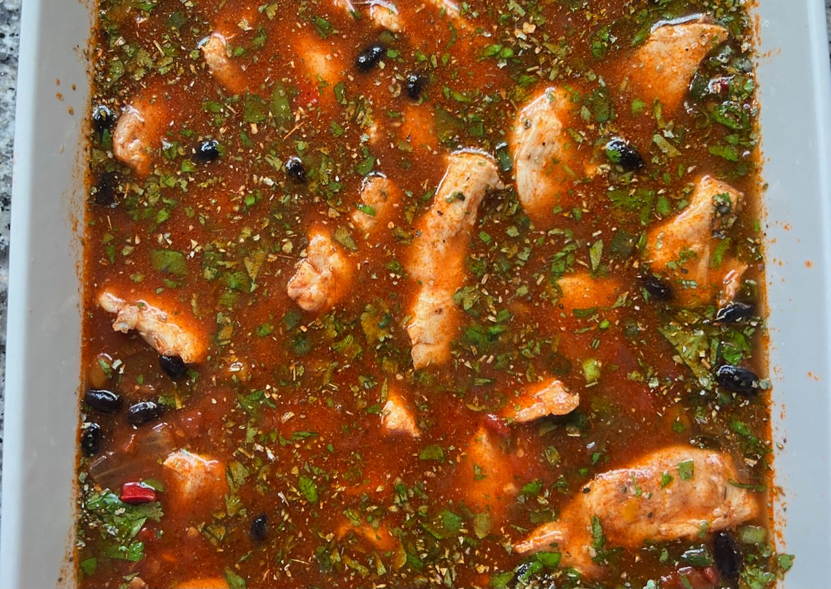 Chicken added to all of the other ingredients in a casserole dish for Salsa Chicken Casserole Recipe.