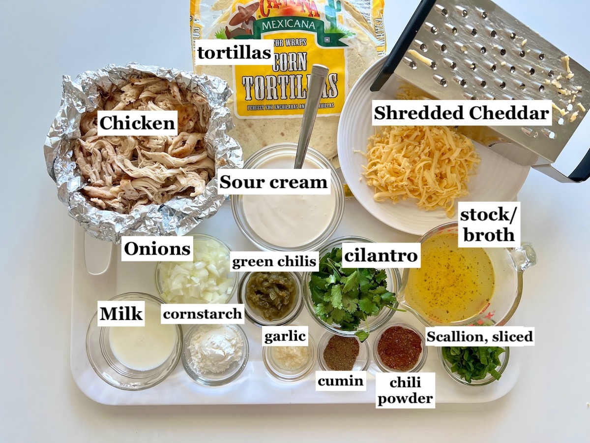 Ingredients chopped, diced, and measured out into bowls and then labeled for this crockpot white chicken enchilada casserole.