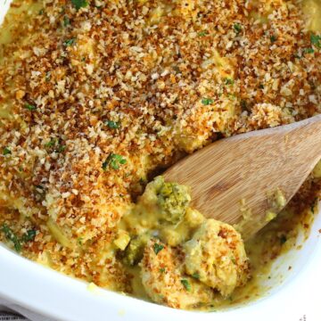 Wooden Spatula scooping the corner of Creamy Broccoli Chicken Curry Casserole Recipe from the casserole dish.