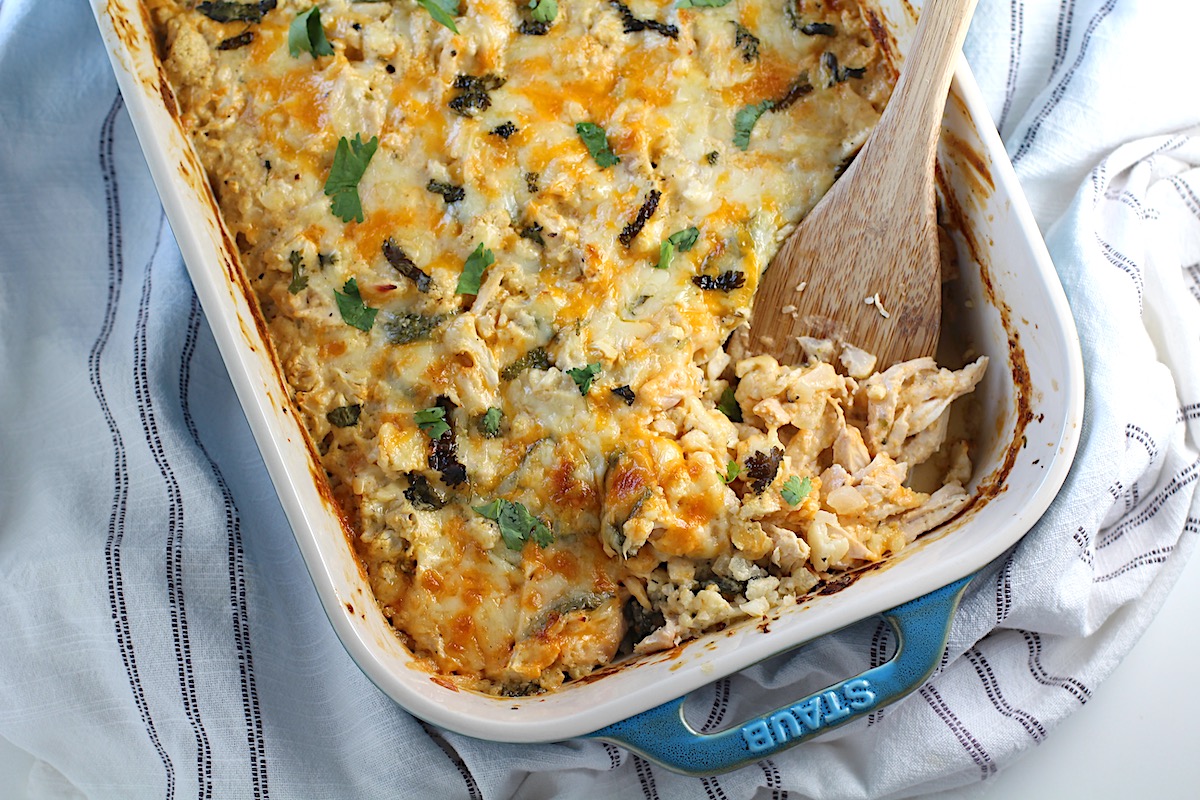 Chicken Cauliflower Rice Bake in a casserole dish with a spatula scooping it in the corner.