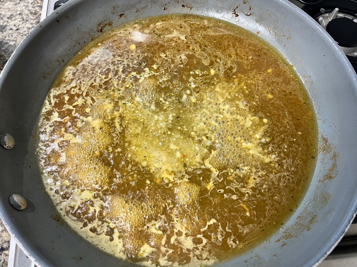 Vodka and broth added to deglaze the pan for Chicken and Vodka Pasta.