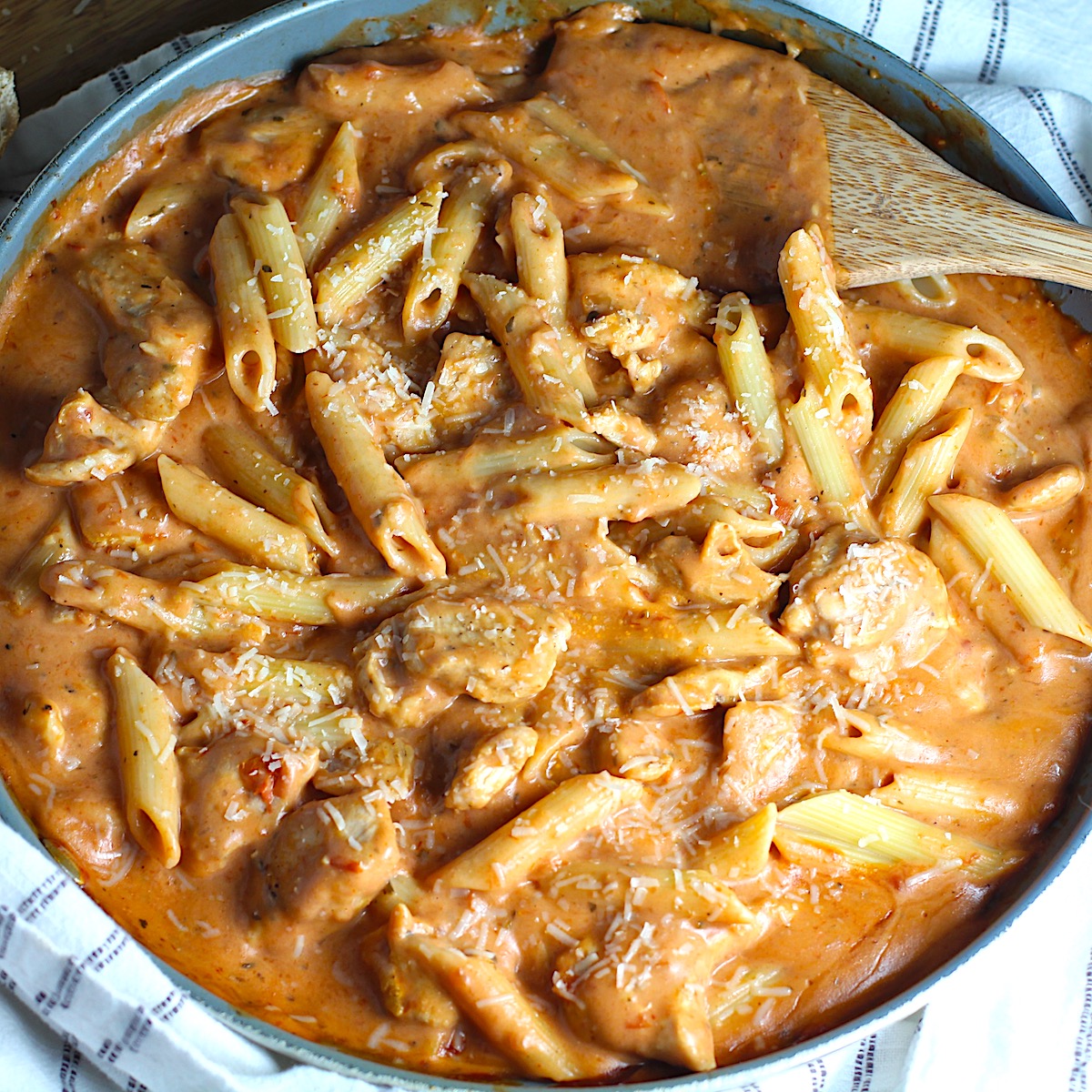 Chicken and penne pasta mixed into the tomato vodka sauce for Creamy Chicken and Vodka Pasta recipe.