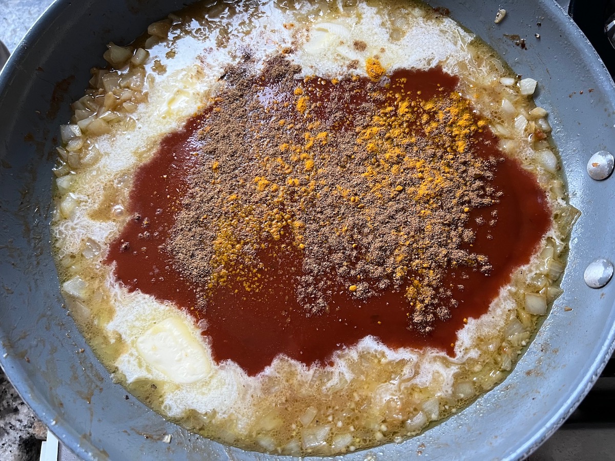 Tomato sauce and seasonings added to the chicken broth mixture.