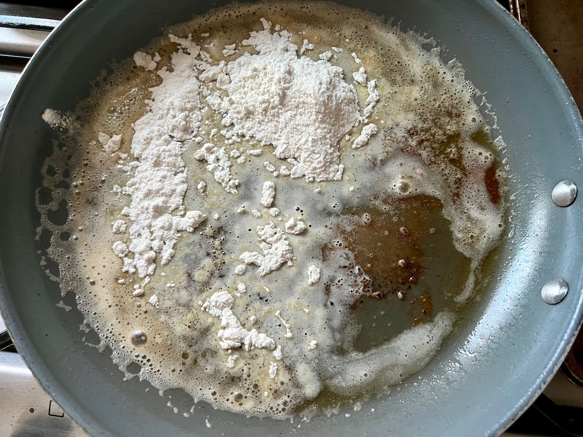 Flour and melted butter in a skillet to prepare gravy.