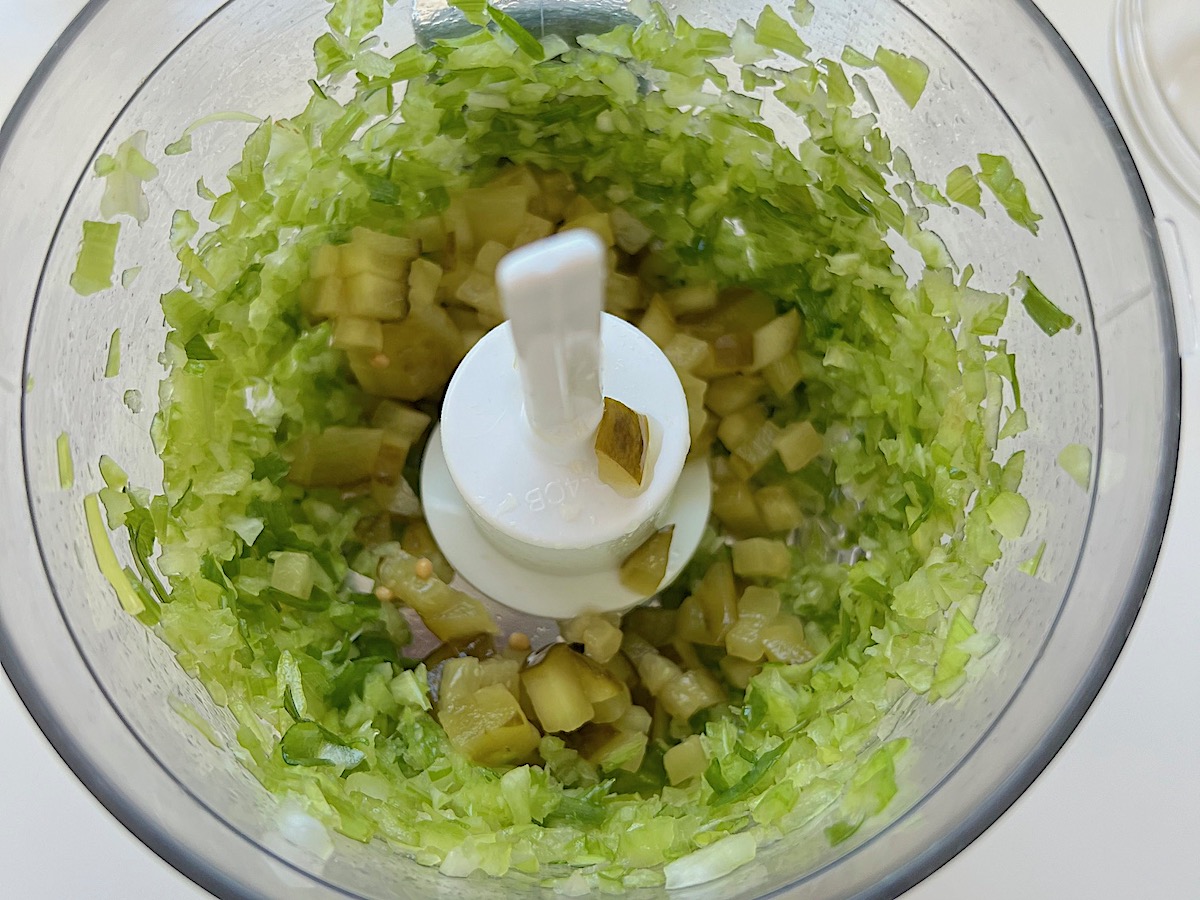 Dill pickles, celery and scallions chopped in a food processor.