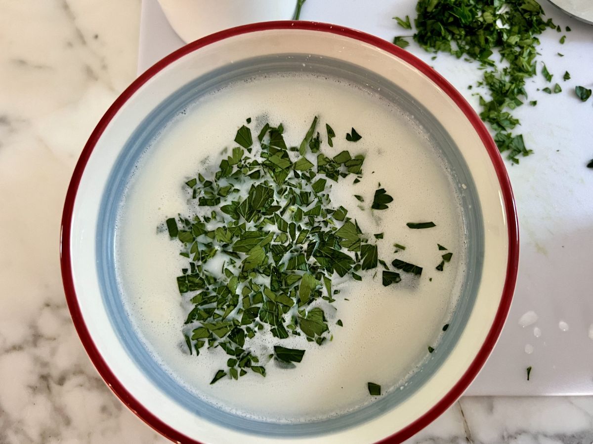 Chopped parsley added to the Parmesan milk mixture.