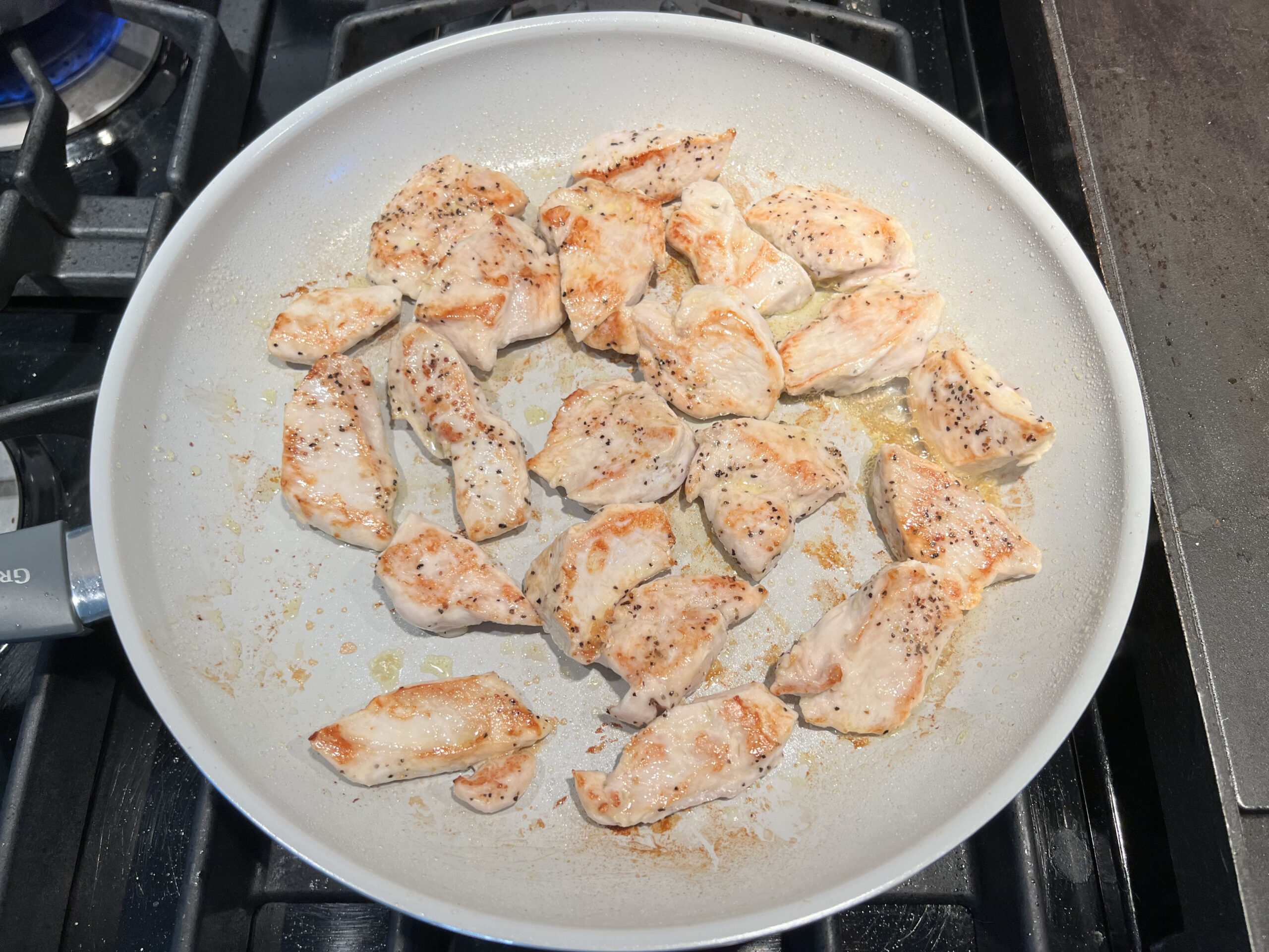 Browned chicken in a skillet for Garlic Chicken Parmesan Pasta recipe.