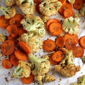 Roasted carrots and cauliflower on a baking sheet.
