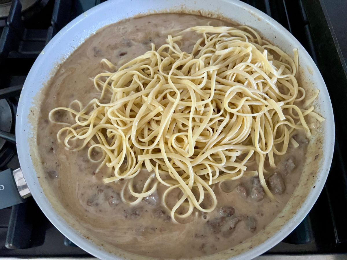 Cooked linguine added to the Alfredo ground beef sauce.