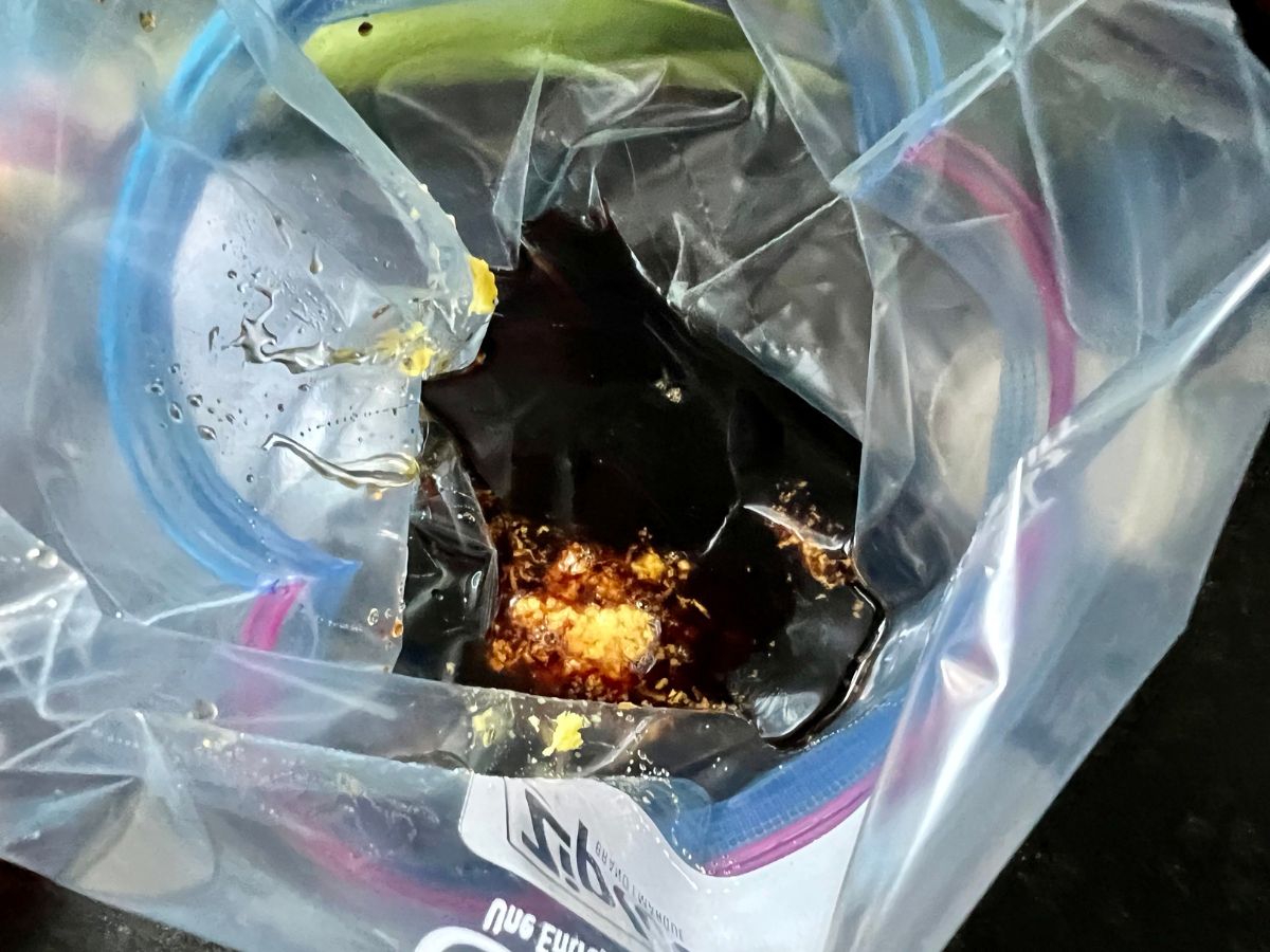 Honey ginger sauce ingredients being added to a ziploc bag.