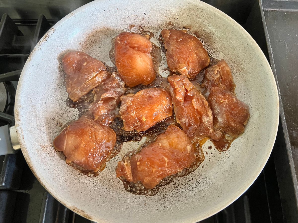 Skillet with chicken sauted in a honey ginger sauce.
