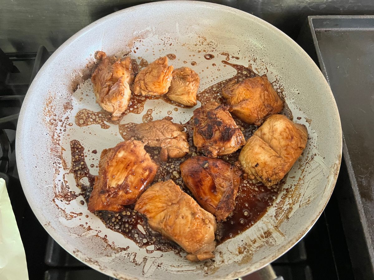Honey ginger chicken in a skillet coated in a thickened sauce