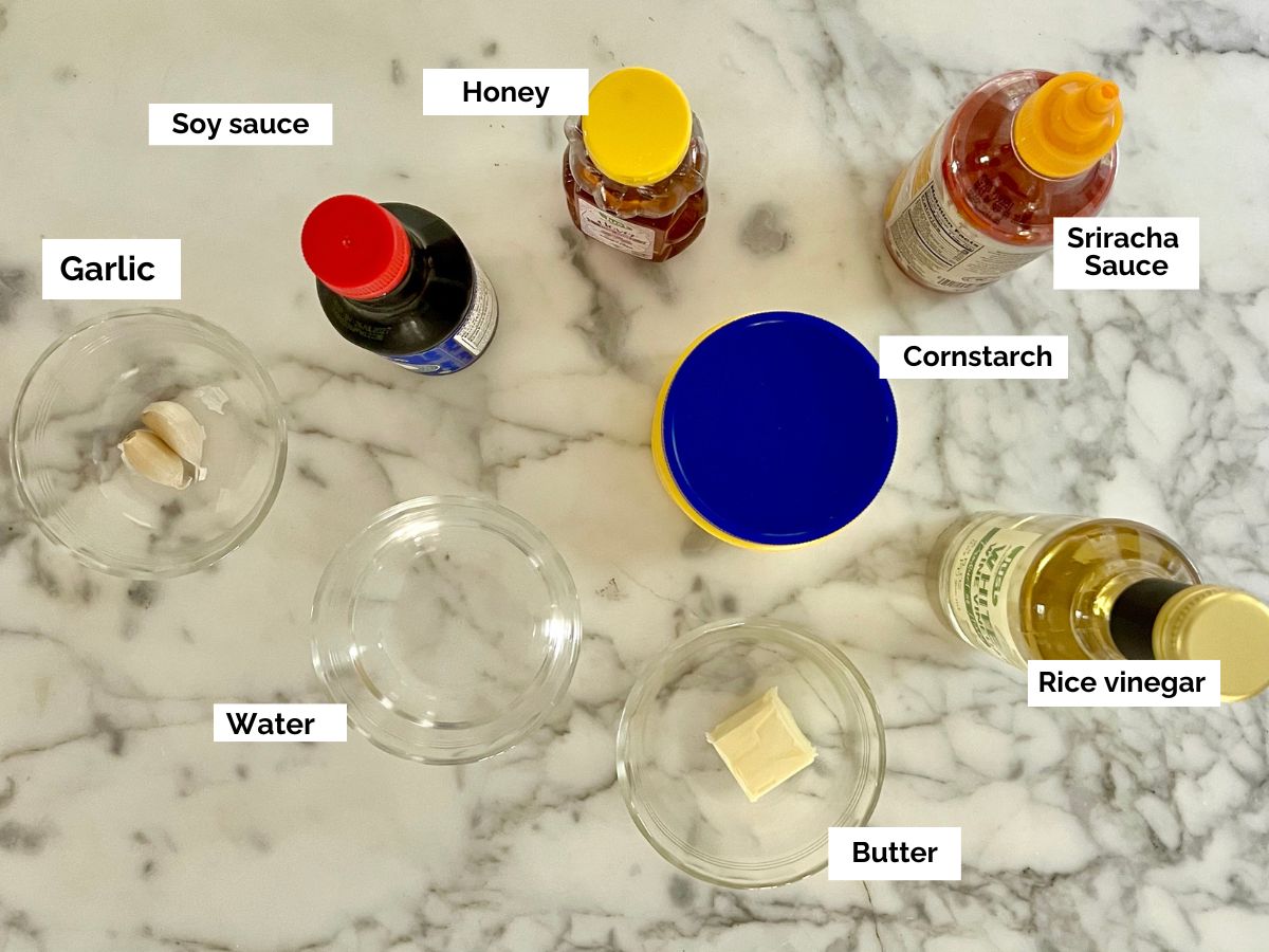 Ingredients shown are used to prepare honey sriracha sauce.