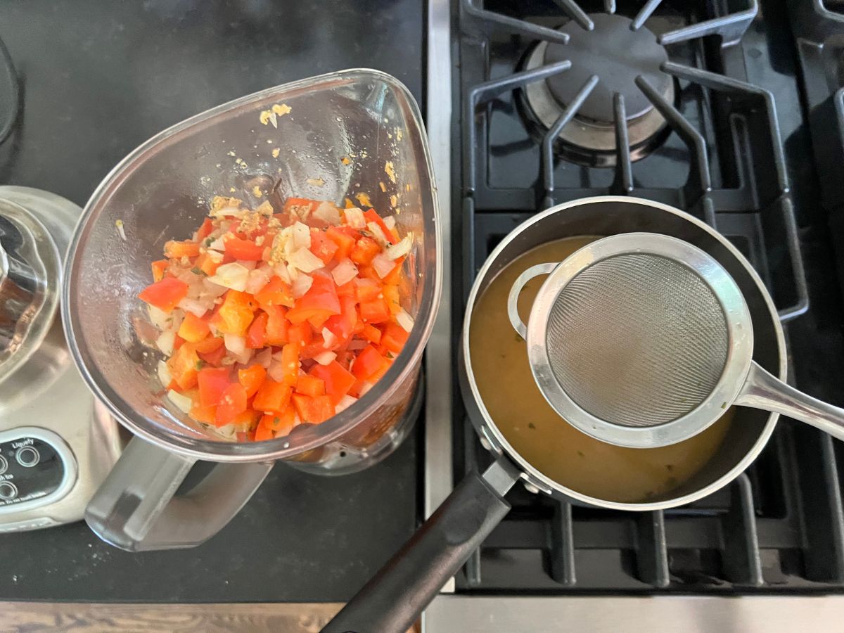 Red peppers and onions added to the blender and the remaining liquid combined with the sweet potato stock in a saucepan.