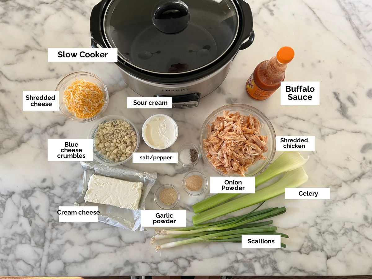 Ingredients shown are used to prepare slow cooker buffalo chicken dip.