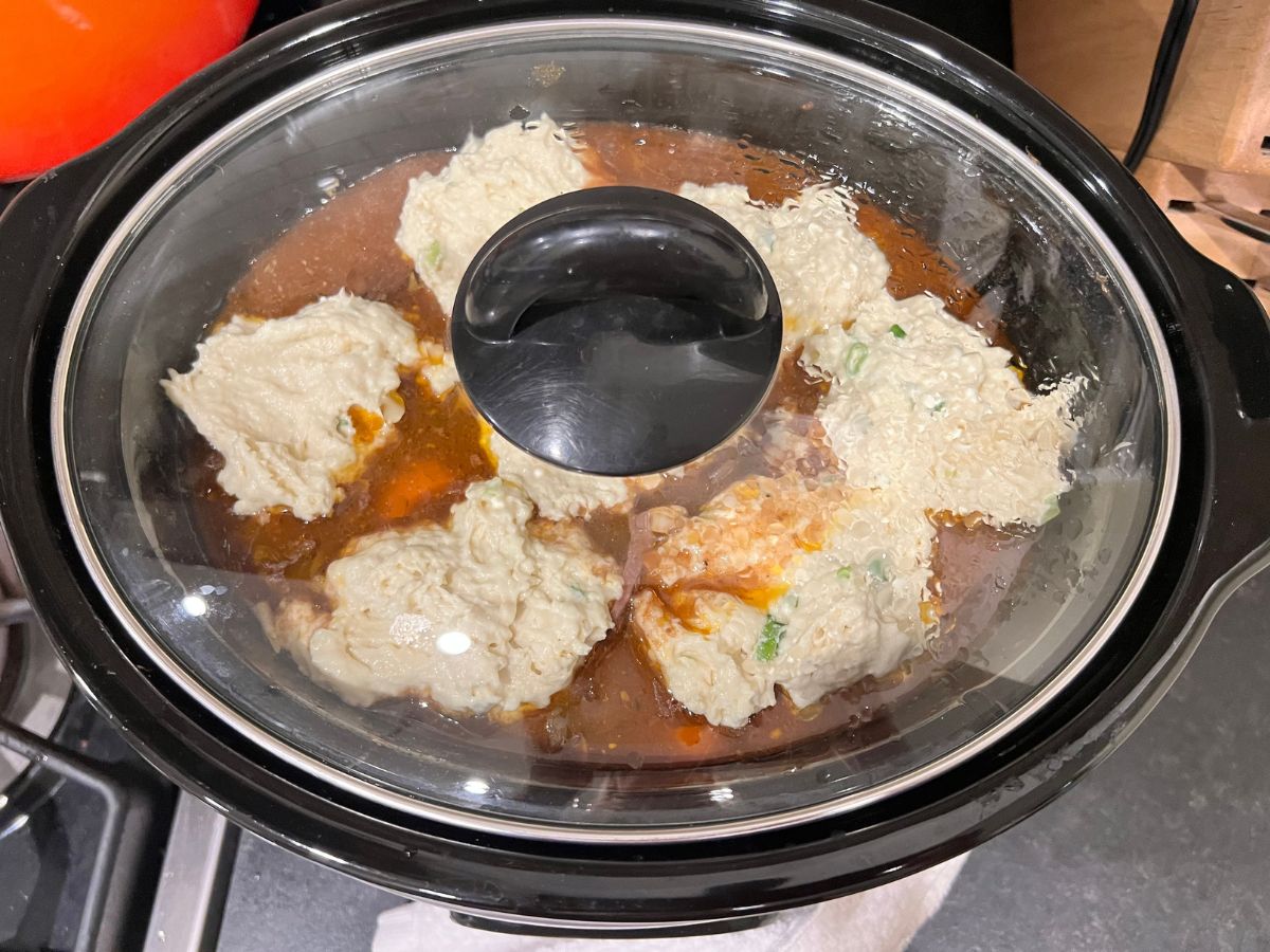 Cover added to the slow cooker for the dumplings to cook over the beef stew.