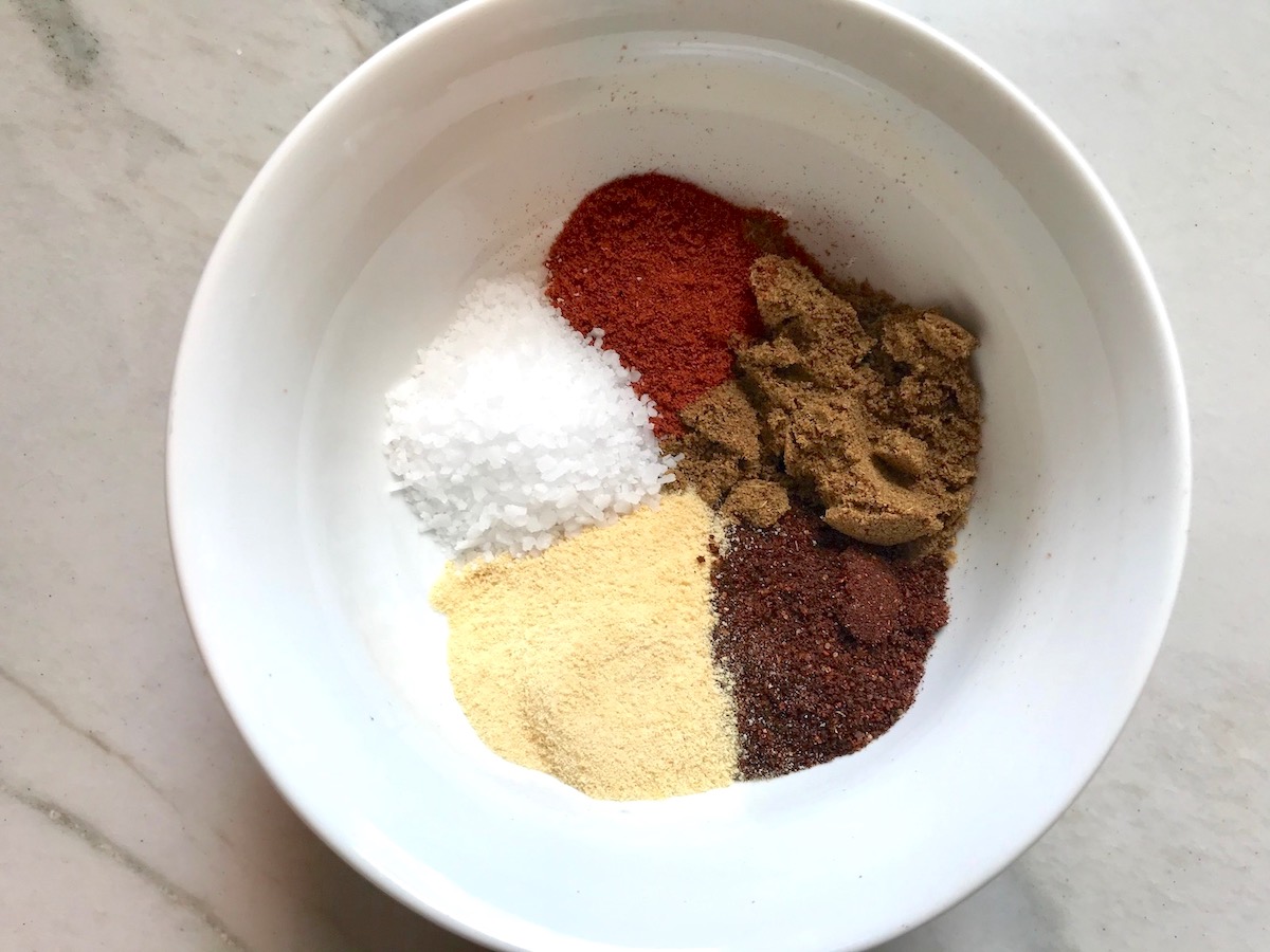 Taco Seasoning for Chicken Recipe -seasonings separated in bowl (clockwise) smoked paprika, cumin, chili powder, garlic powder, and salt.