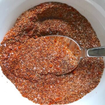 Taco Seasoning for Chicken Recipe -seasonings mixed in bowl (clockwise) smoked paprika, cumin, chili powder, garlic powder, and salt.