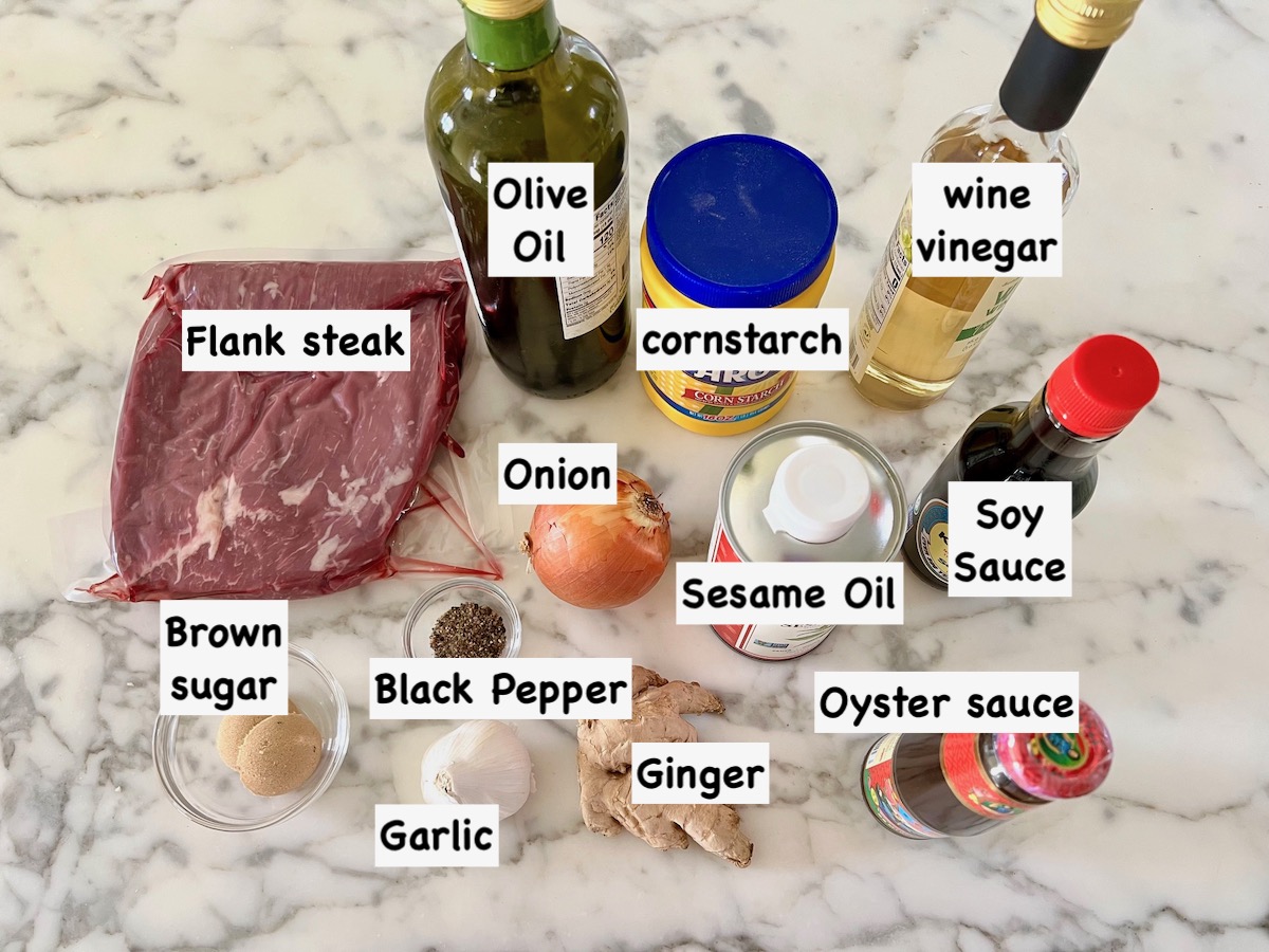 Ingredients labeled on counter for Black Pepper Beef Stir Fry with onions.