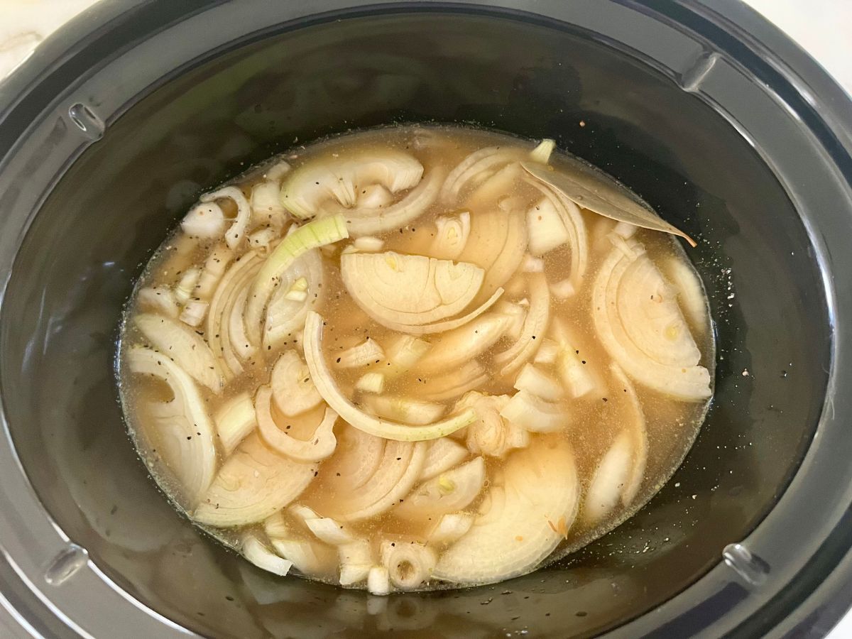 Chicken broth and worcestershire sauce added to crockpot.
