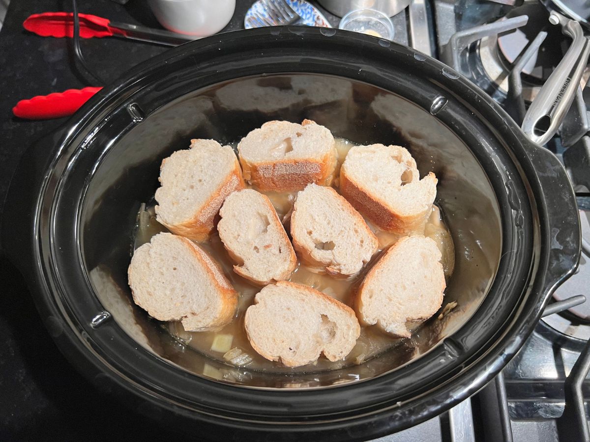 Sliced baguette added to the crockpot over the Chicken French Onion soup.