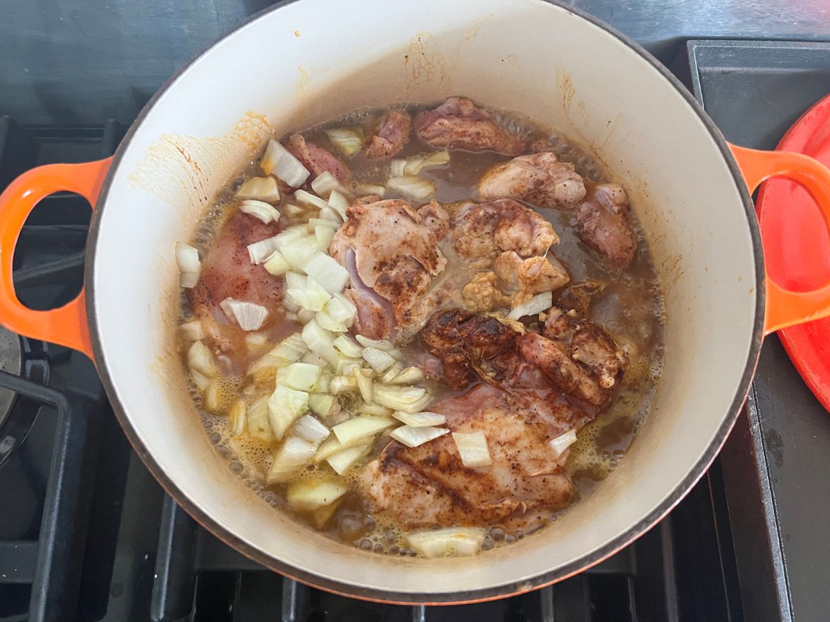 Broth added to the chicken in the Dutch oven.