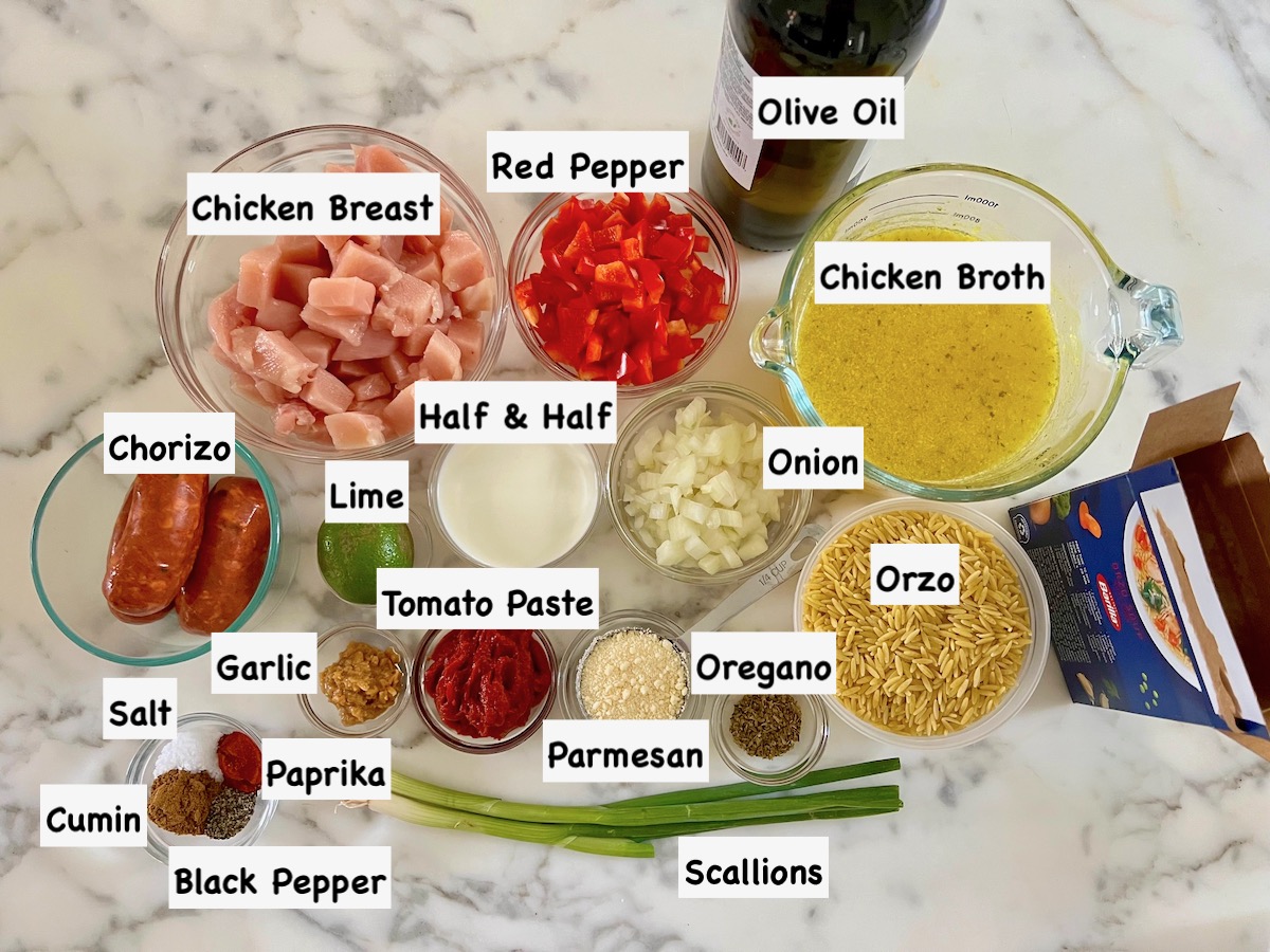 Ingredients prepared and measured out into individual bowls with labels on the image for Chicken Chorizo Orzo recipe.