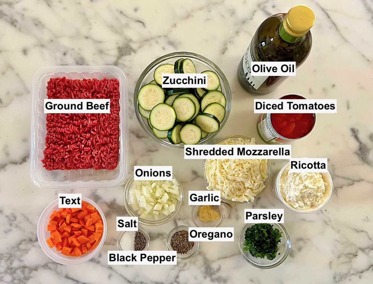 Ingredients prepped and measured out in small bowls, labeled on counter for Ground Beef and Zucchini Casserole recipe.