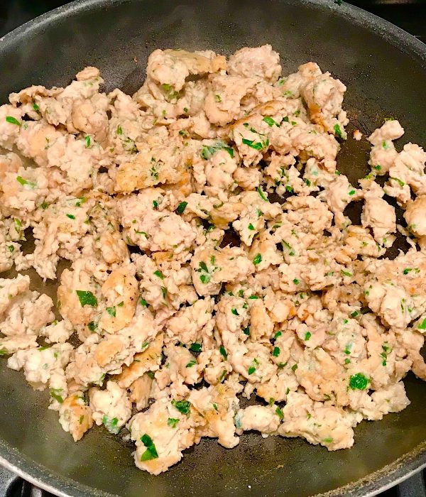 Ground Italian Chicken Sausage cooked in a frying pan.